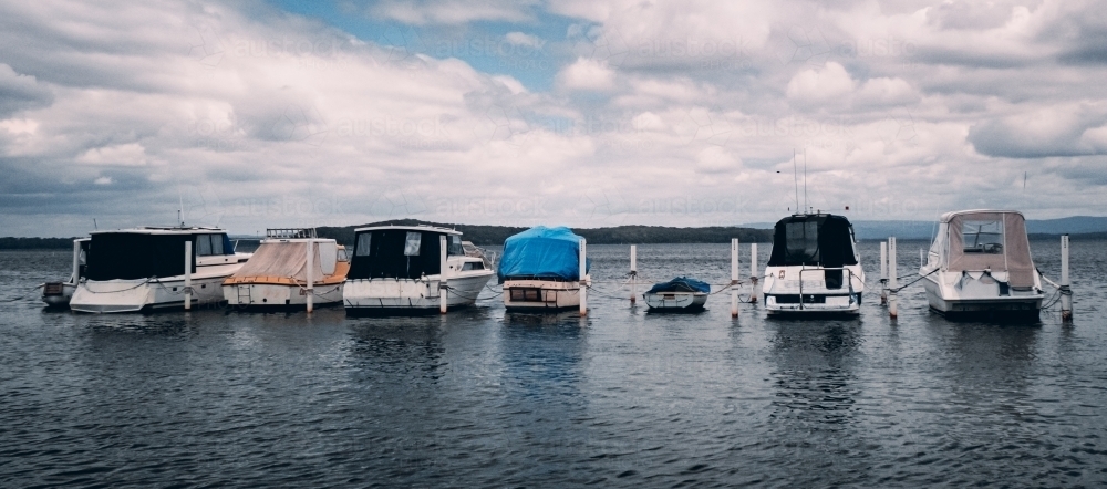 Group of Boats Moored on a calm Lake - Australian Stock Image