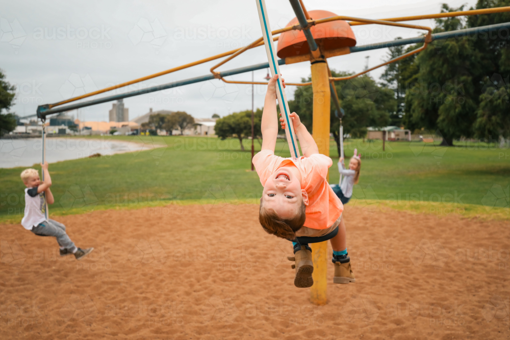 Image of Group of children riding four person swing on the Portland ...