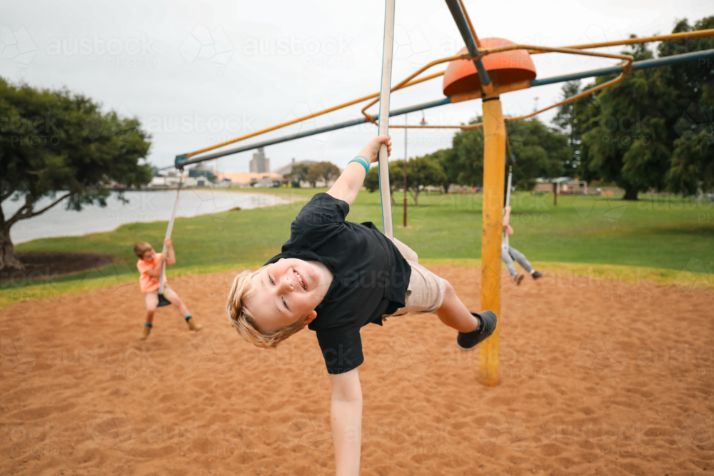 Image of Group of children riding four person swing on the Portland ...