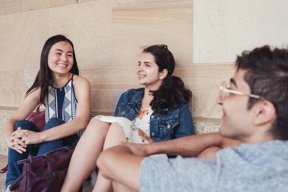Group of happy international students in university library - Australian Stock Image