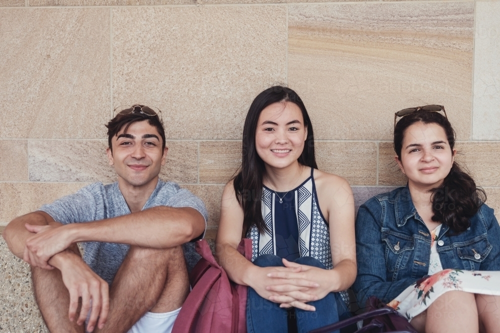 Group of happy international students in university library - Australian Stock Image