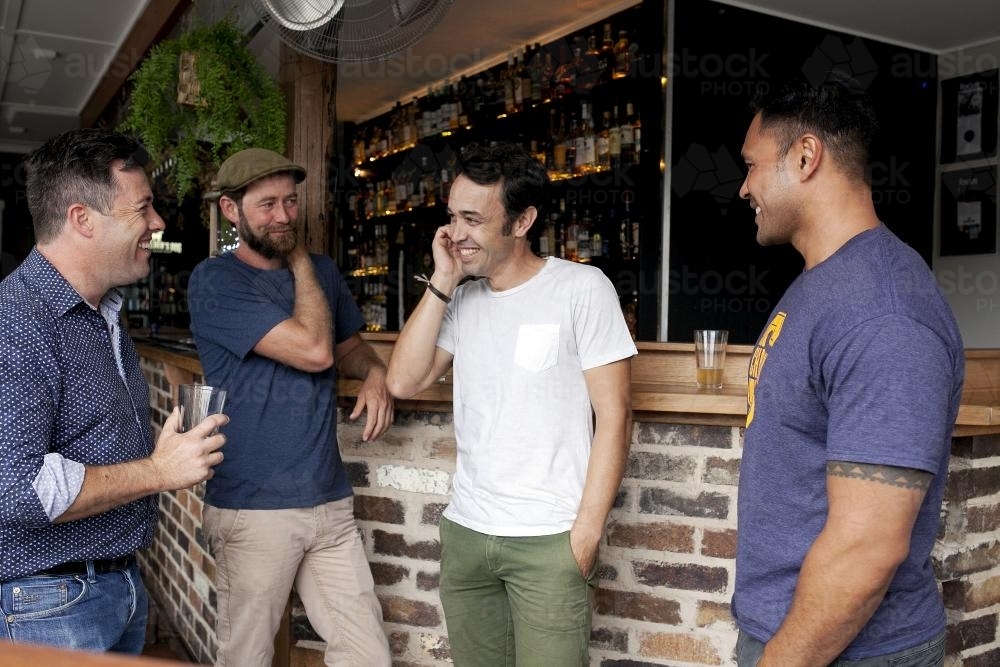 Group of mates having a drink at local craft beer pub - Australian Stock Image