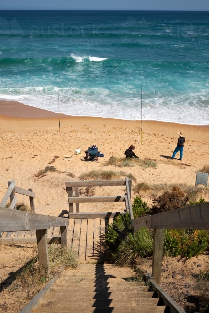 Group of Men Fishing on a Surf Beach - Australian Stock Image