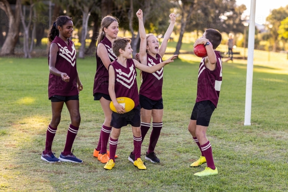 Image Of Group Of School Kids In Football Team Cheering Each Other image-of-group-of-school-kids-in-football-team-cheering-each-other