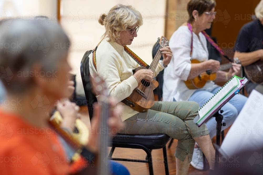group of seniors playing ukulele - Australian Stock Image