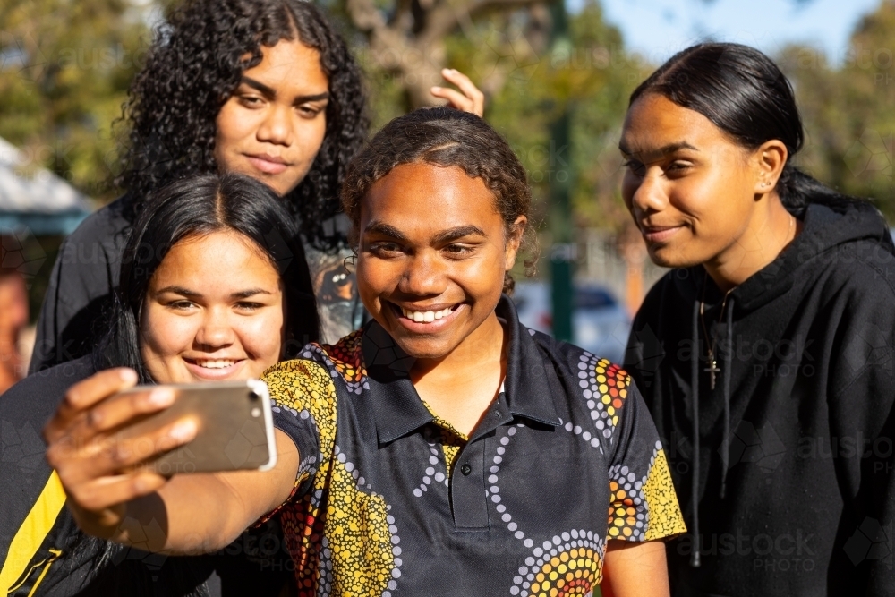 group of teen girls posing for selfie outdoors - Australian Stock Image