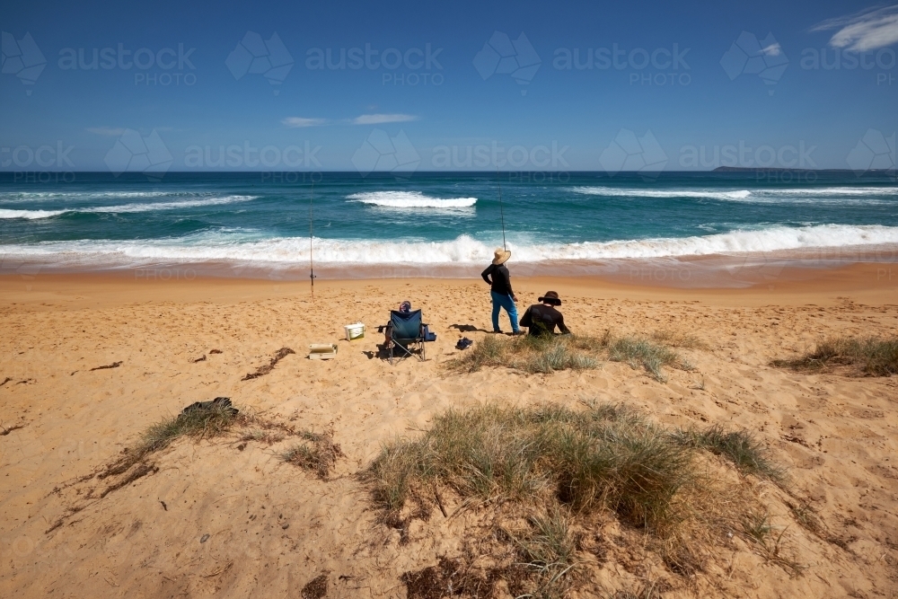 Group of Three Men Fishing on a Surf Beach - Australian Stock Image