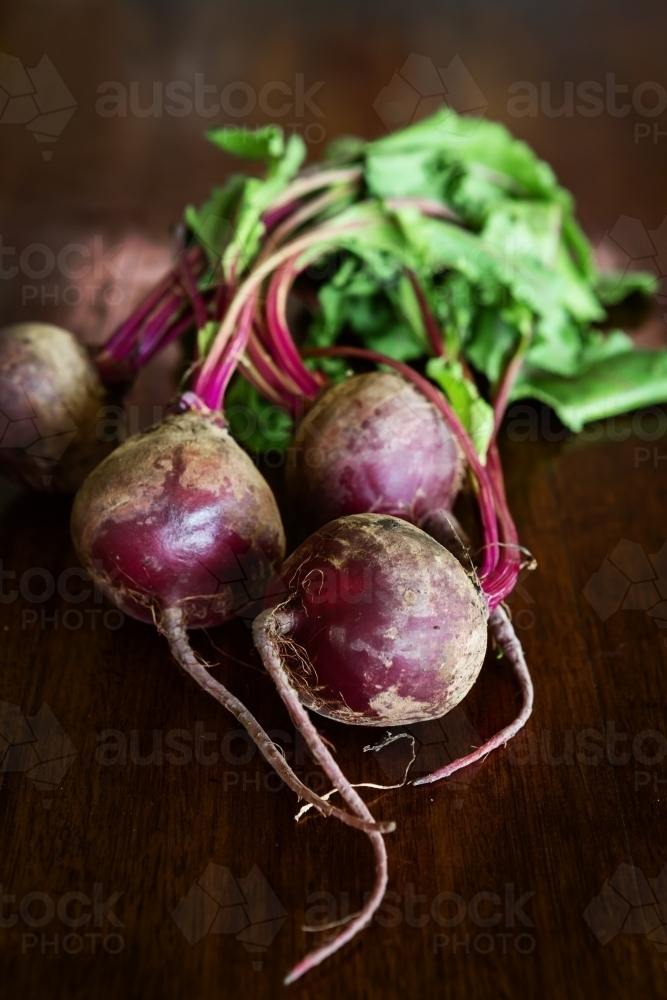 Group of whole beetroot vegetable on a wooden table - Australian Stock Image