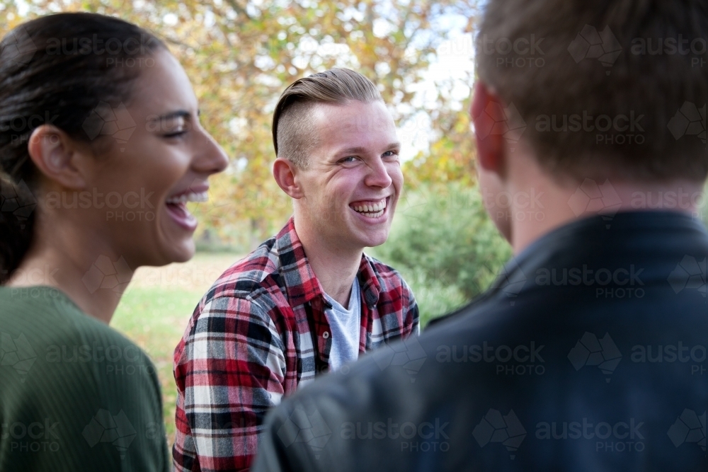 Group of young people laughing outdoors - Australian Stock Image