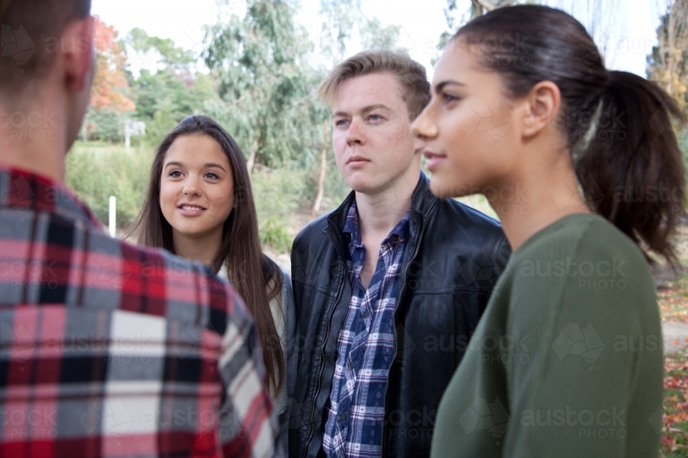Group of young people talking in an outdoor setting - Australian Stock Image