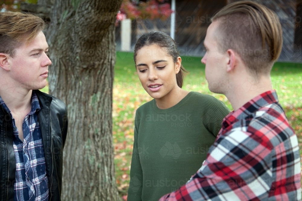 Group of young people talking in an outdoor setting - Australian Stock Image