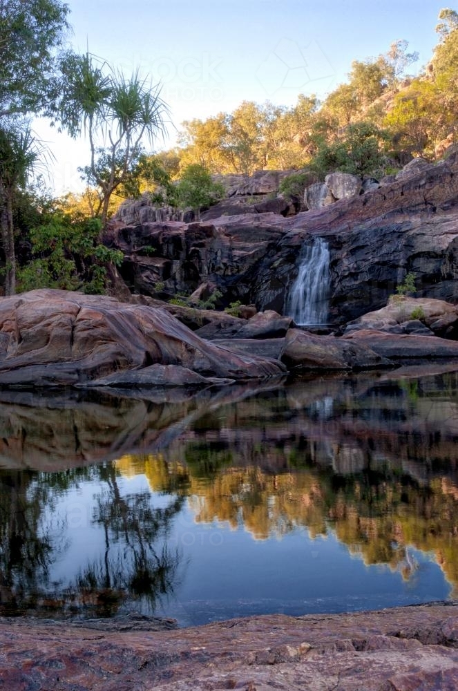 Gunlom watering hole with falls and reflection - Australian Stock Image