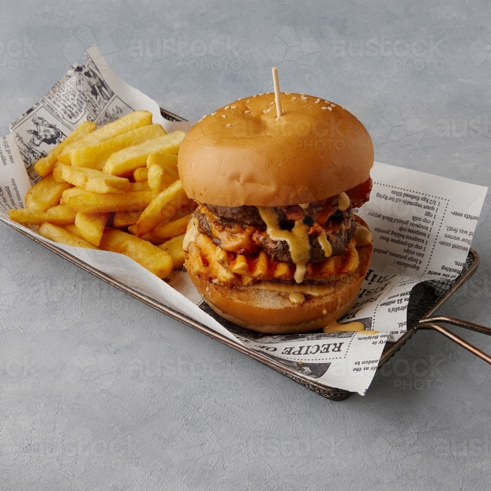 Image of Hamburger and chips on table Austockphoto
