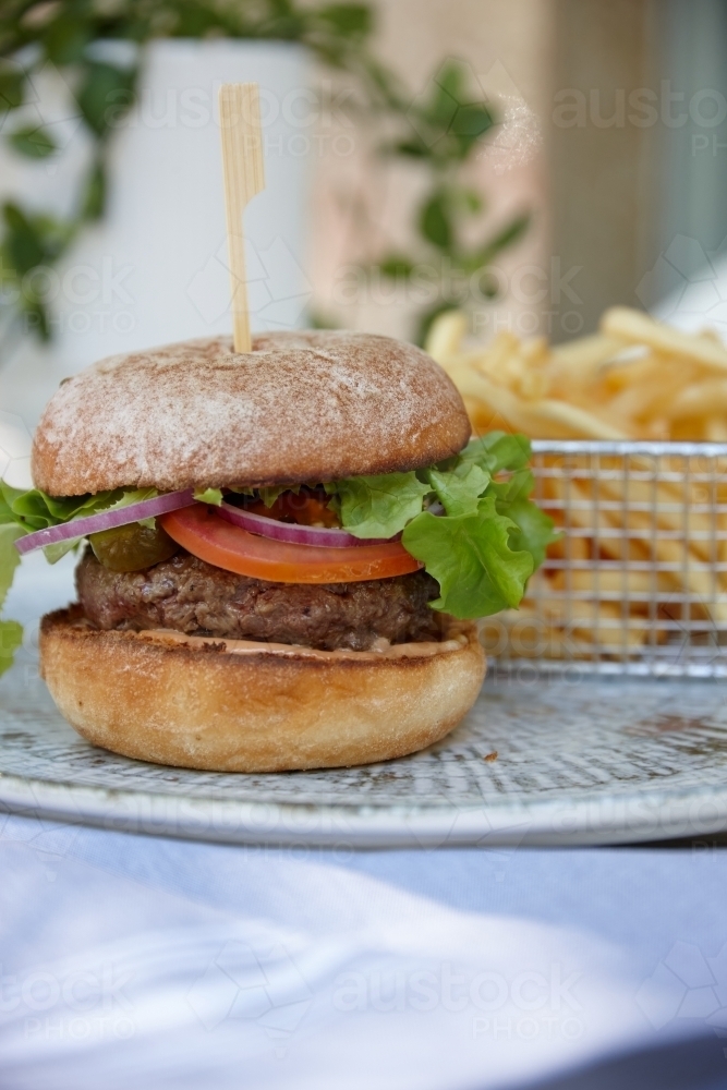 Hamburger and chips on table - Australian Stock Image