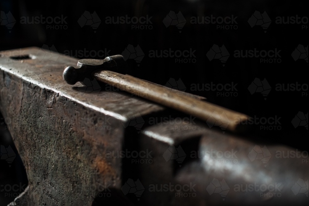 Hammer sitting on anvil - Australian Stock Image