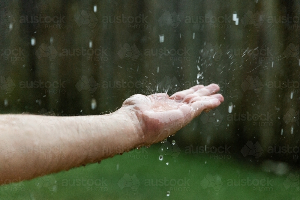 Image of hand catching raindrops - Austockphoto