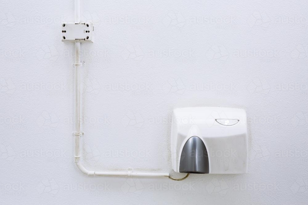 Hand dryer in an outdoor public toilet - Australian Stock Image