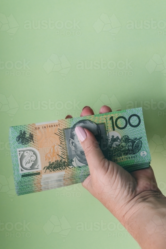 hand holding $100 notes - Australian Stock Image