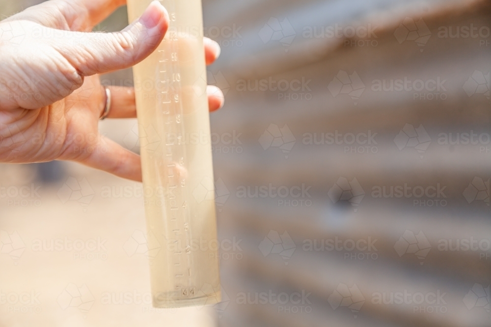 Hand holding empty rain gauge drought concept - Australian Stock Image