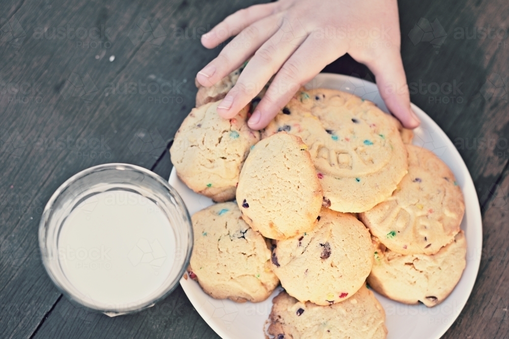 hand reaching for home made cookies - Australian Stock Image