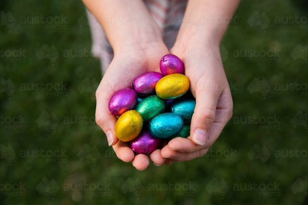 handful of easter eggs over a dark green background - Australian Stock Image