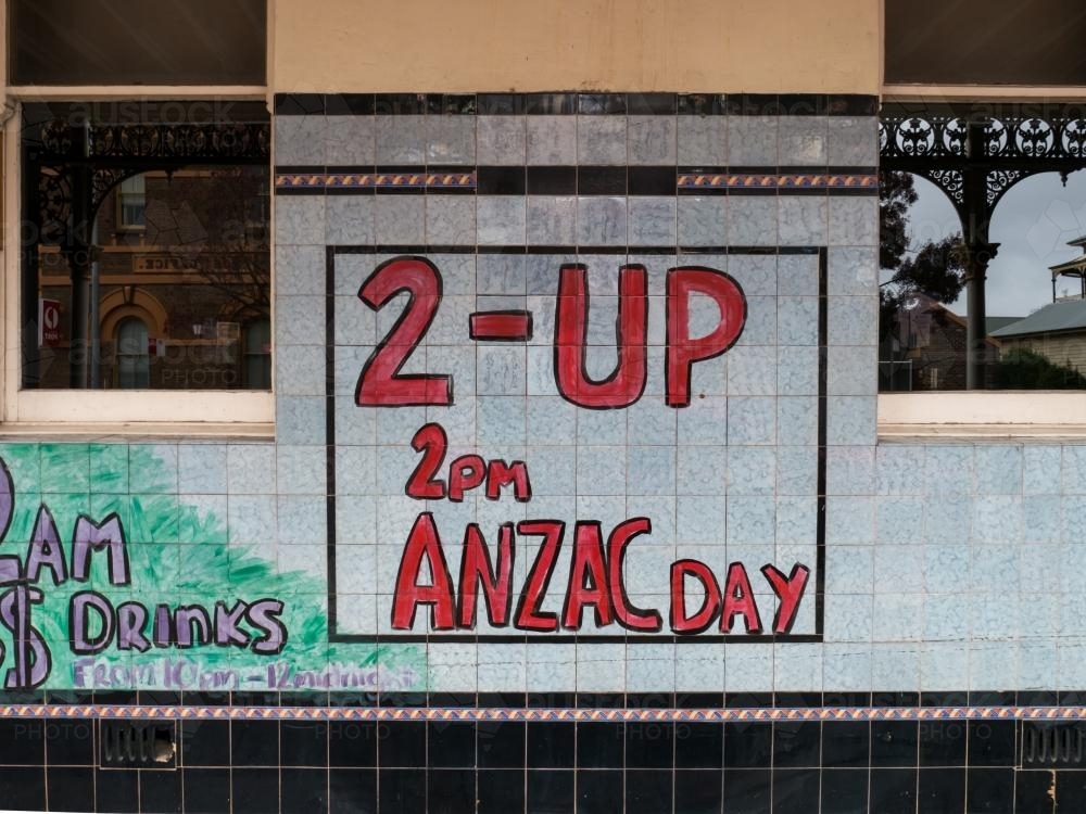 Handmade Two-Up sign on a tiled pub wall - Australian Stock Image