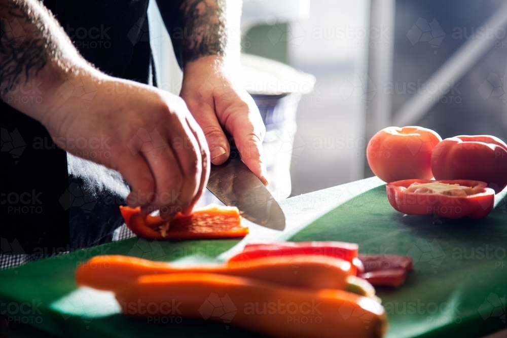 Hands chopping vegetables - Australian Stock Image