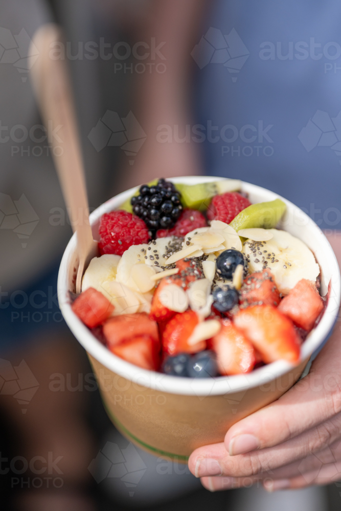 hands holding acai fruit health bowl - Australian Stock Image