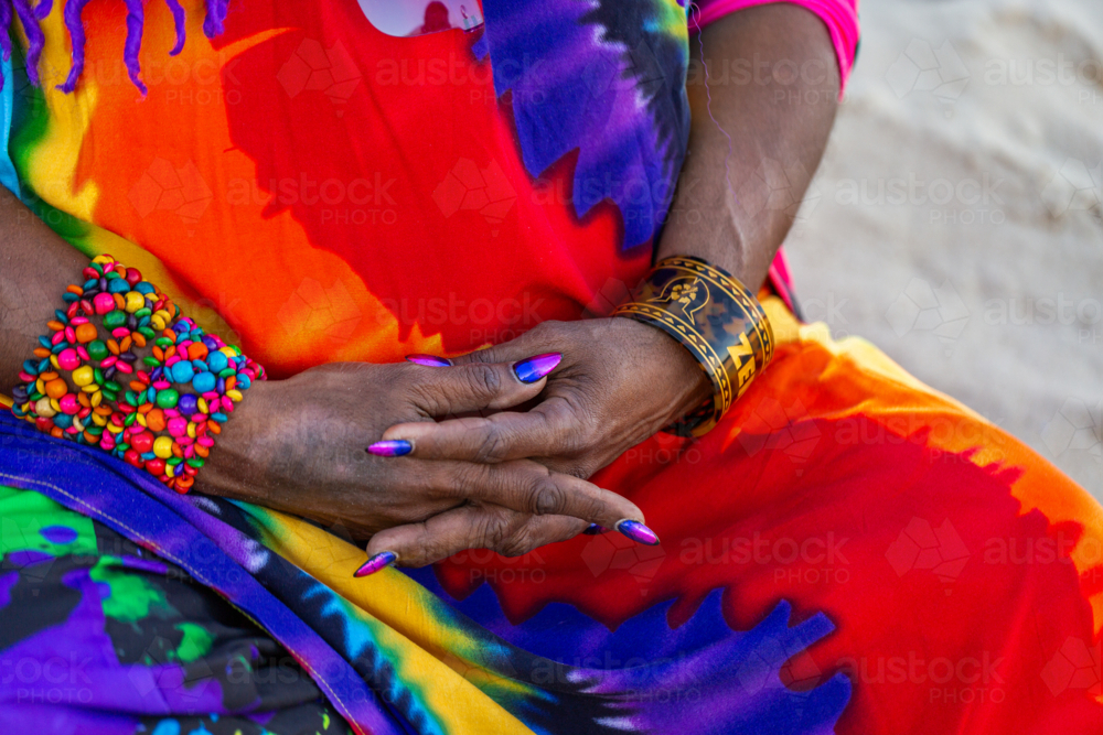 hands of middle aged First Nations Australian Torres Strait Islander woman clasped in lap - Australian Stock Image