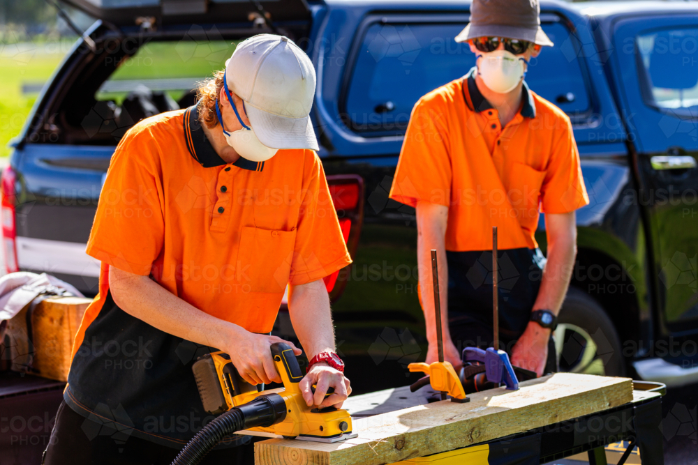hands on tool demonstration during class for trade apprentices using planer tool - Australian Stock Image