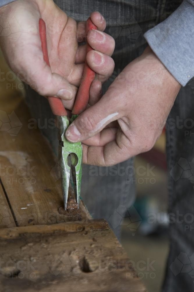 Handyman making a new bedhead from recycled timber - Australian Stock Image