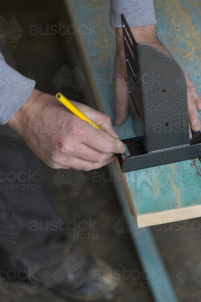 Handyman making a new bedhead from recycled timber - Australian Stock Image