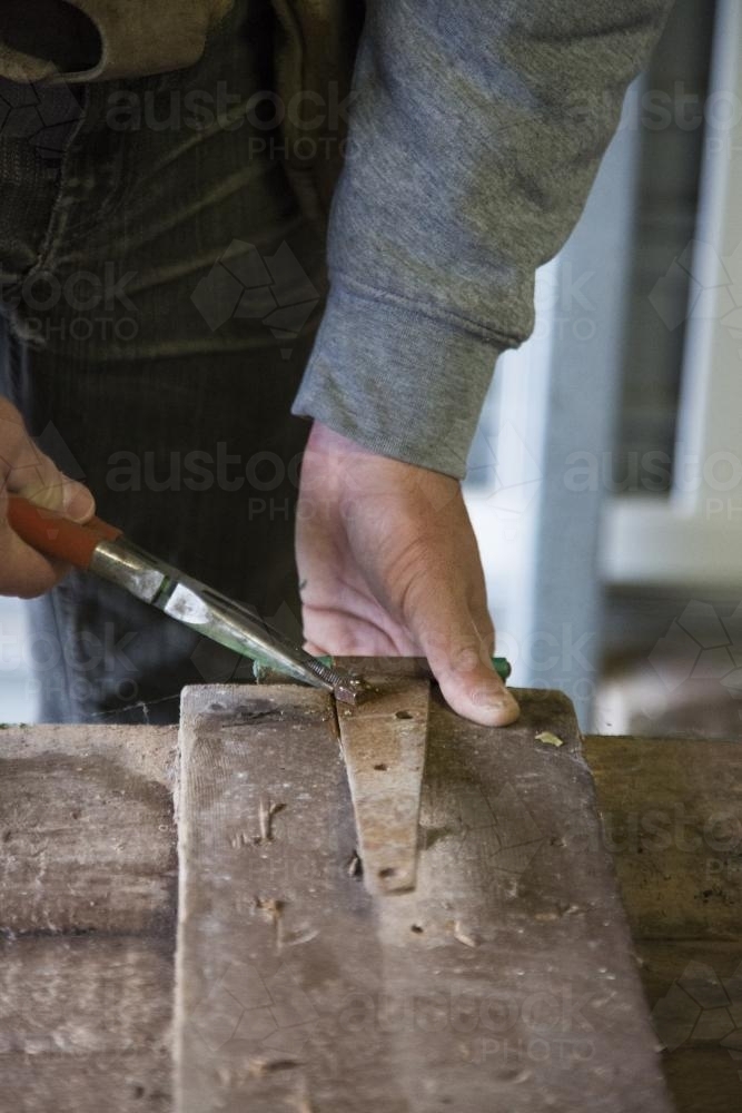 Handyman making a new bedhead from recycled timber - Australian Stock Image