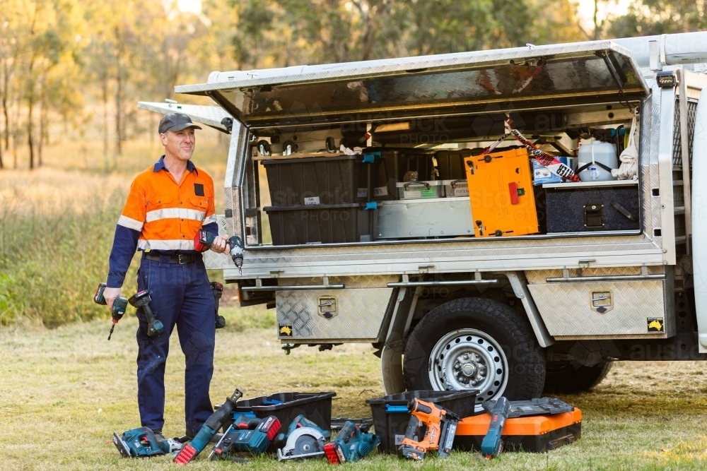 Image of Handyman tradie with power tools and ute ready for work