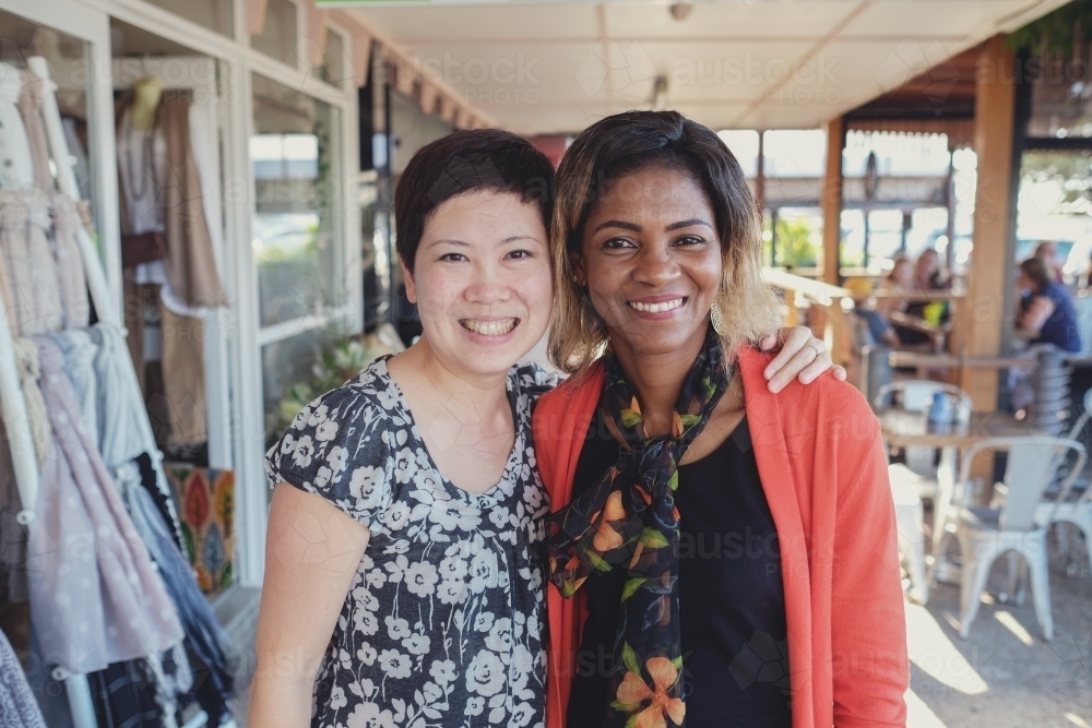 Happy Asian and African women - Australian Stock Image