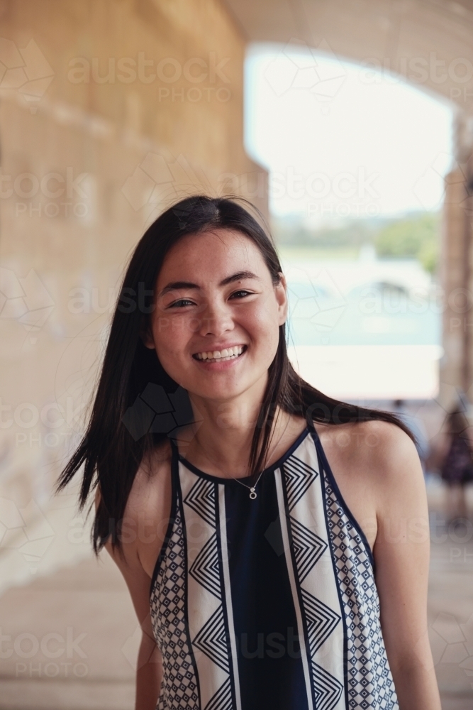 Happy Asian female young adult student in university - Australian Stock Image