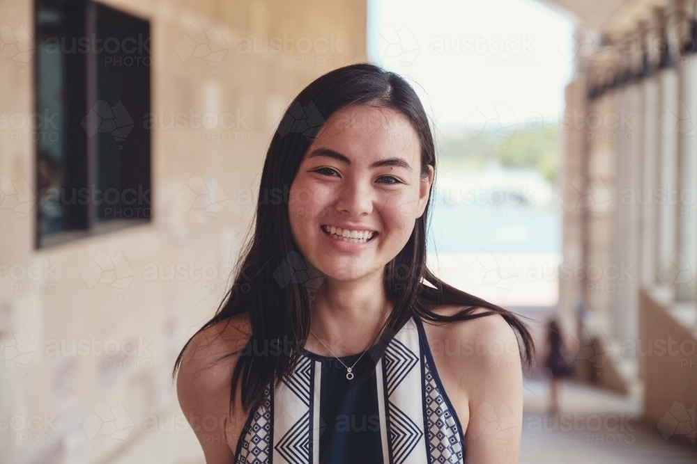 Happy Asian female young adult student in university - Australian Stock Image