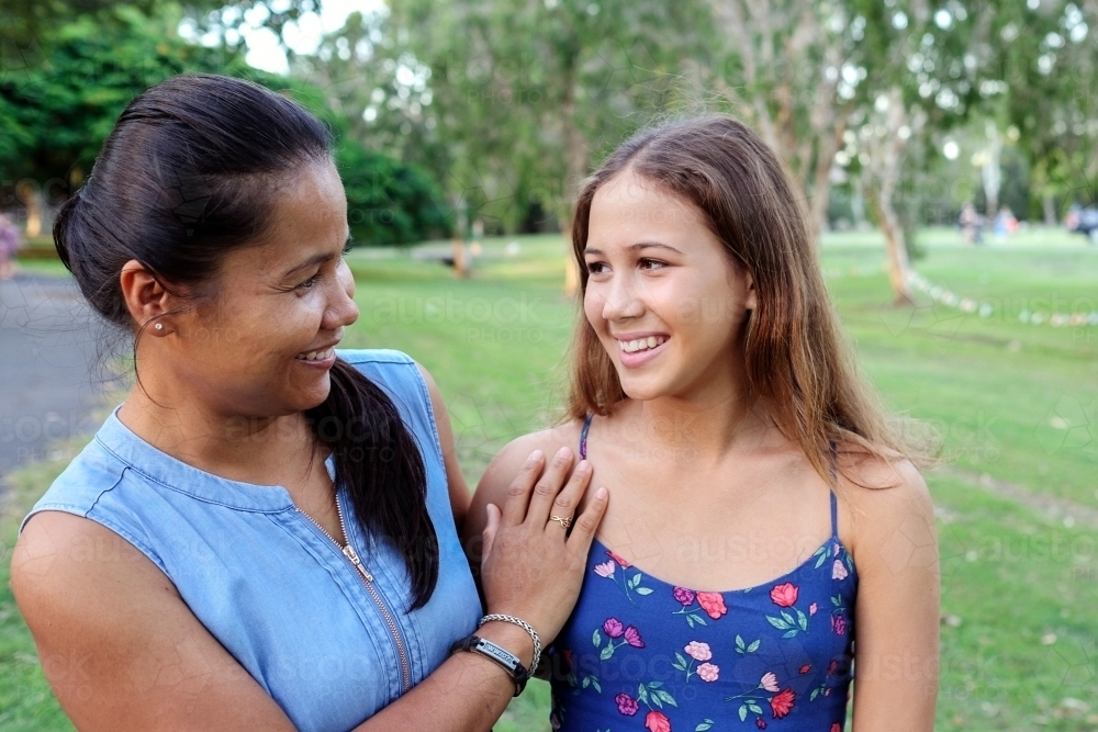 Happy Asian multicultural mother and daughter in the park - Australian Stock Image