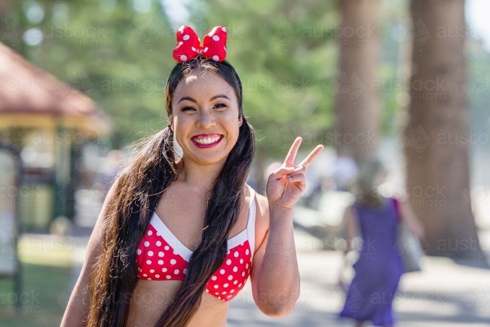 happy Asian woman in bikini - Australian Stock Image