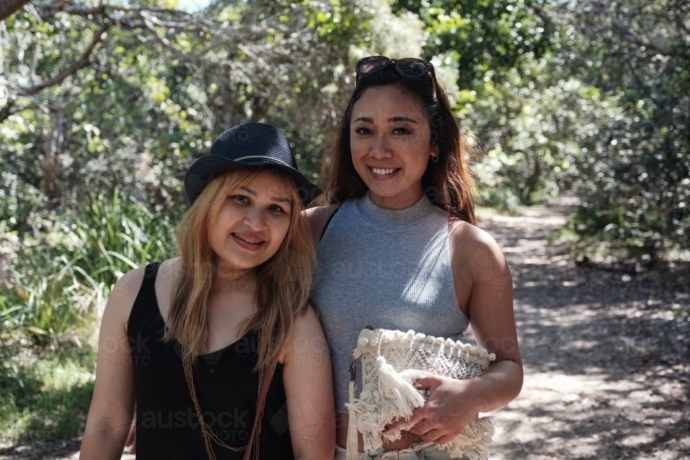 Happy Asian young adult women in the park - Australian Stock Image