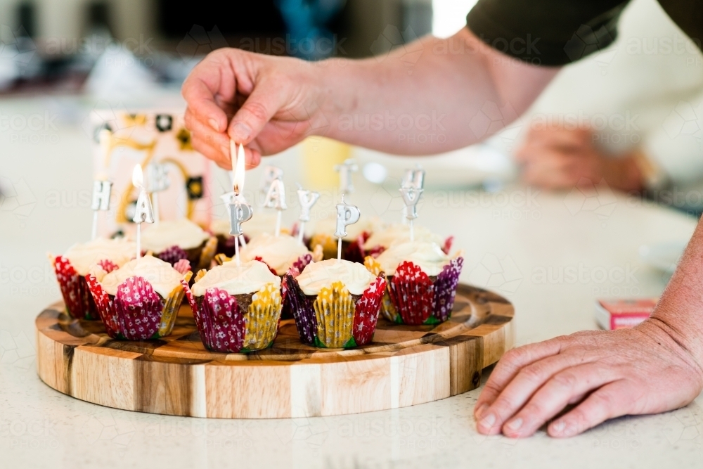 Image of happy birthday candles on cupcakes Austockphoto