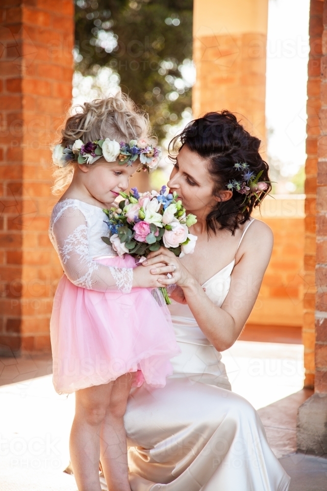 Happy bride and flowergirl outside church ready for wedding - Australian Stock Image