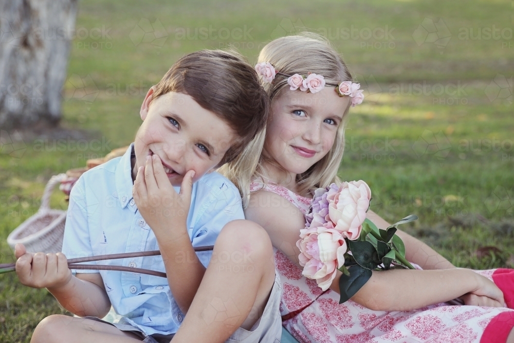Happy brother and big sister in the park - Australian Stock Image