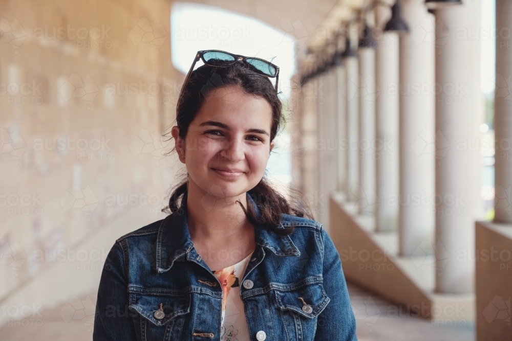 Happy caucasian young female adult woman in university - Australian Stock Image