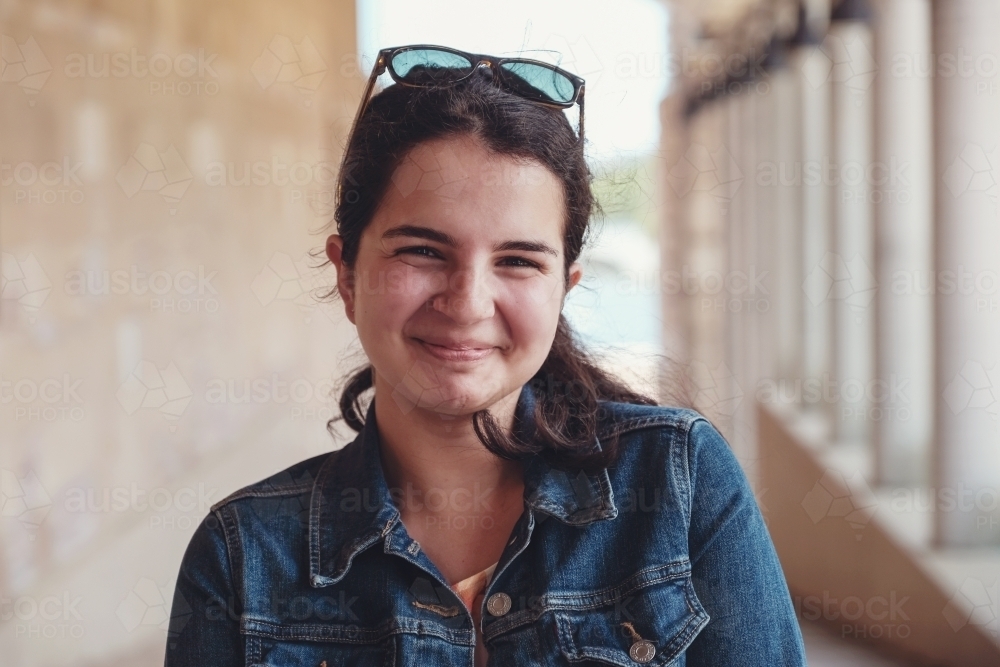 Happy caucasian young female adult woman in university - Australian Stock Image