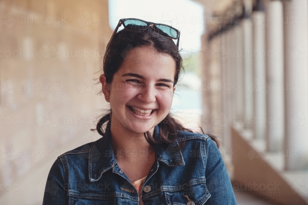 Happy caucasian young female adult woman in university - Australian Stock Image