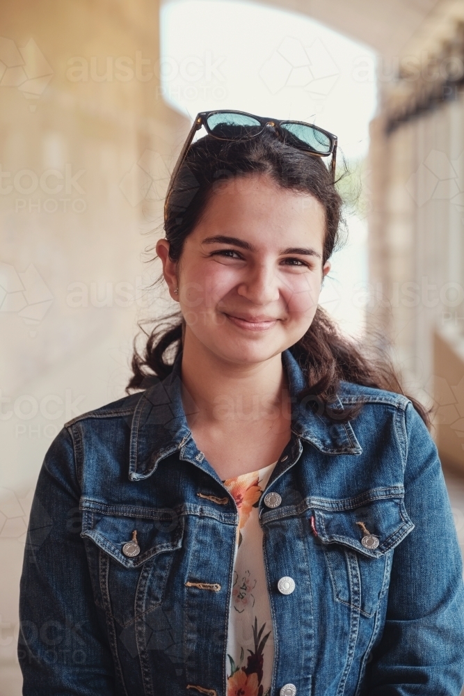 Happy caucasian young female adult woman in university - Australian Stock Image