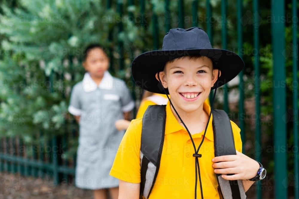 Happy cheeky school boy ready to go back to school - Australian Stock Image
