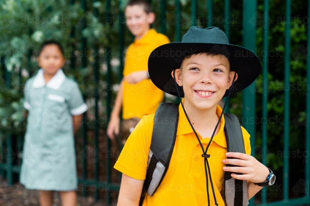 Happy cheeky school boy ready to go back to school - Australian Stock Image
