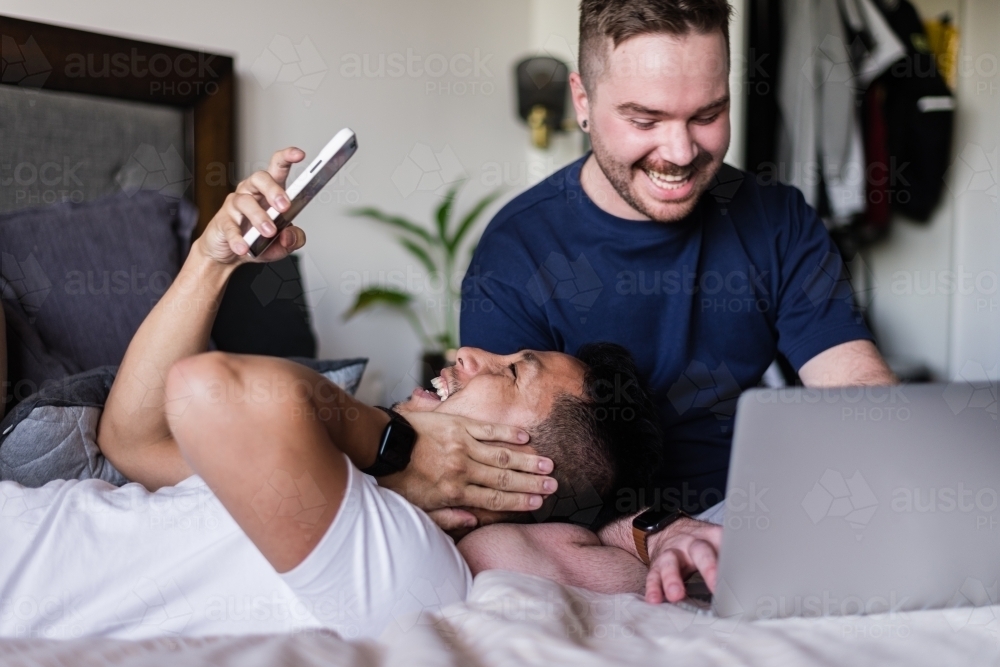 happy couple hanging out at home - Australian Stock Image